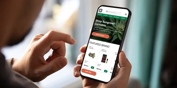 Customer browsing a dispensary website on a mobile phone—demonstrating mobile optimization for cannabis dispensary SEO.