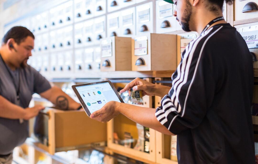 Employees managing inventory with digital tablet