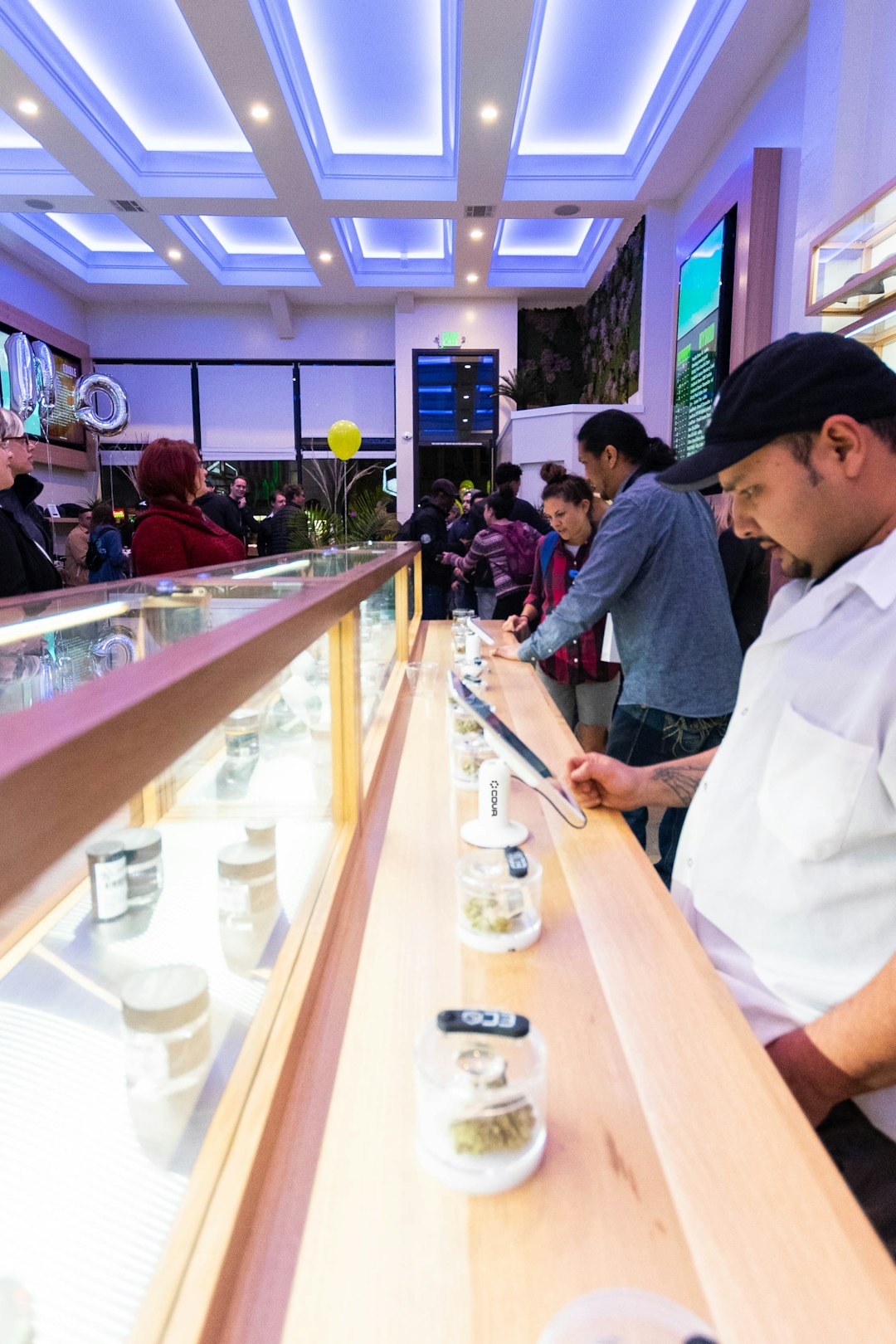 Cannabis dispensary interior with customers browsing