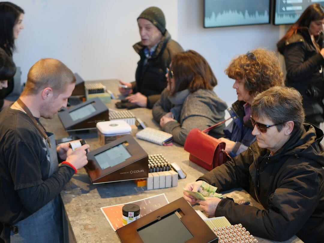 Customers at cannabis store counter purchasing products