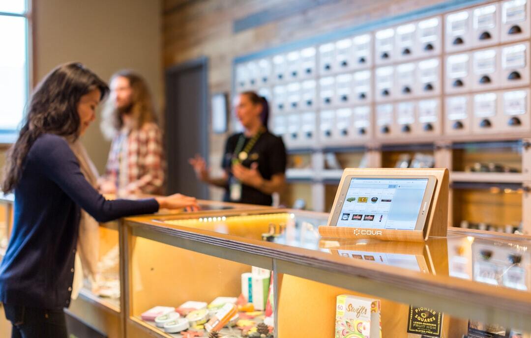 Dispensary counter with customer and staff