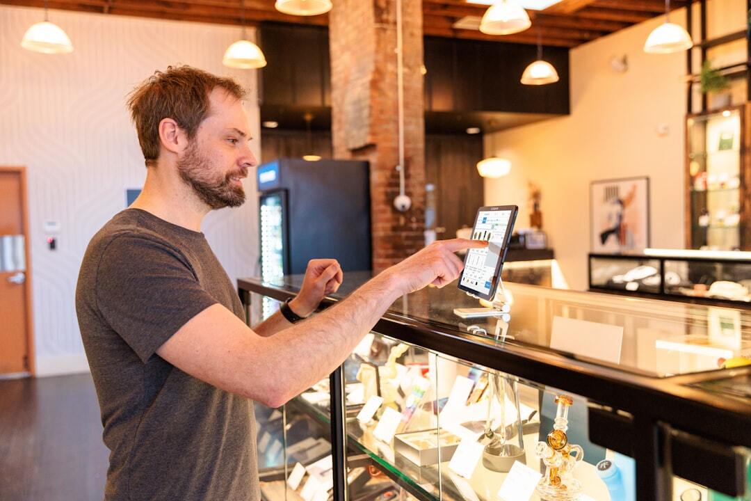 Man using tablet in modern shop setting