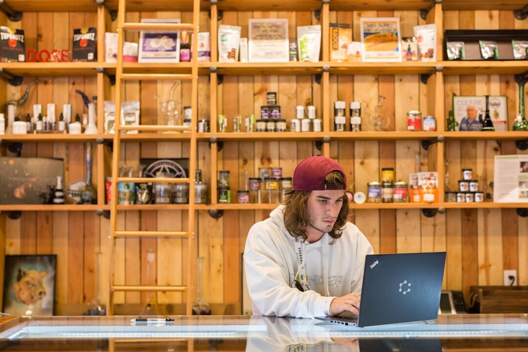 Man working on laptop in rustic shop