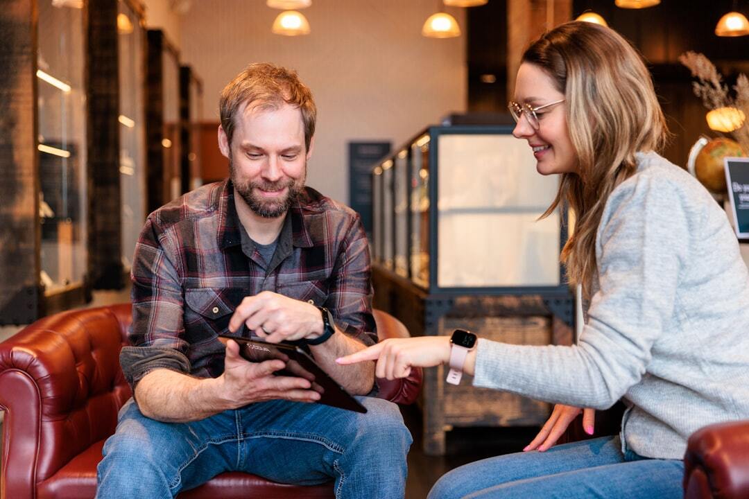 People discussing and smiling over a tablet