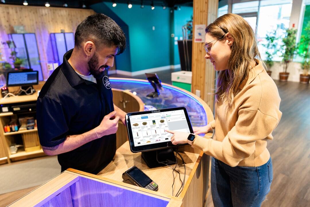 Retail staff using digital sales screen